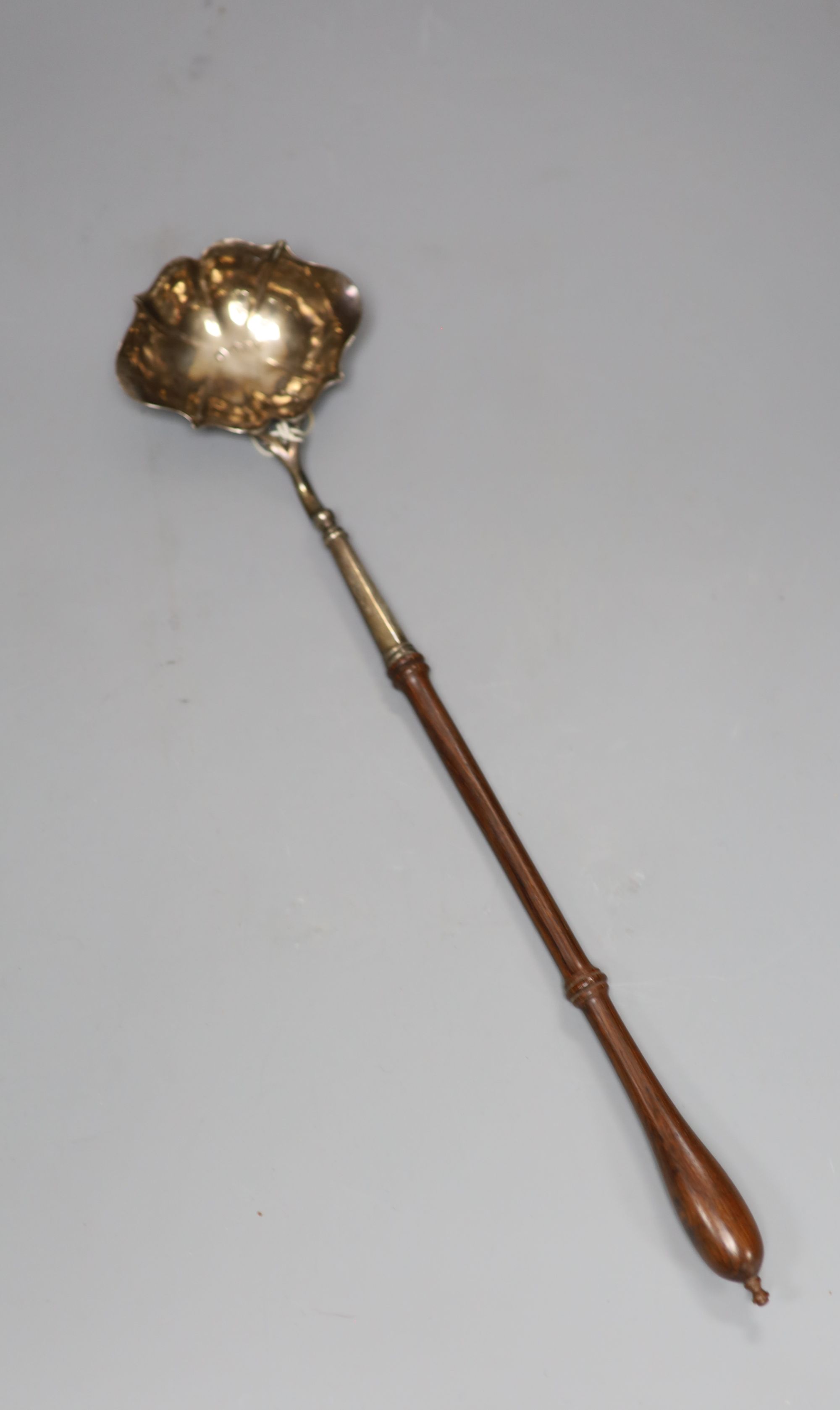 A George II silver toddy ladle, with turned wooden handle, John Pollock, London, 1742, 37.8cm, gross 81 grams.